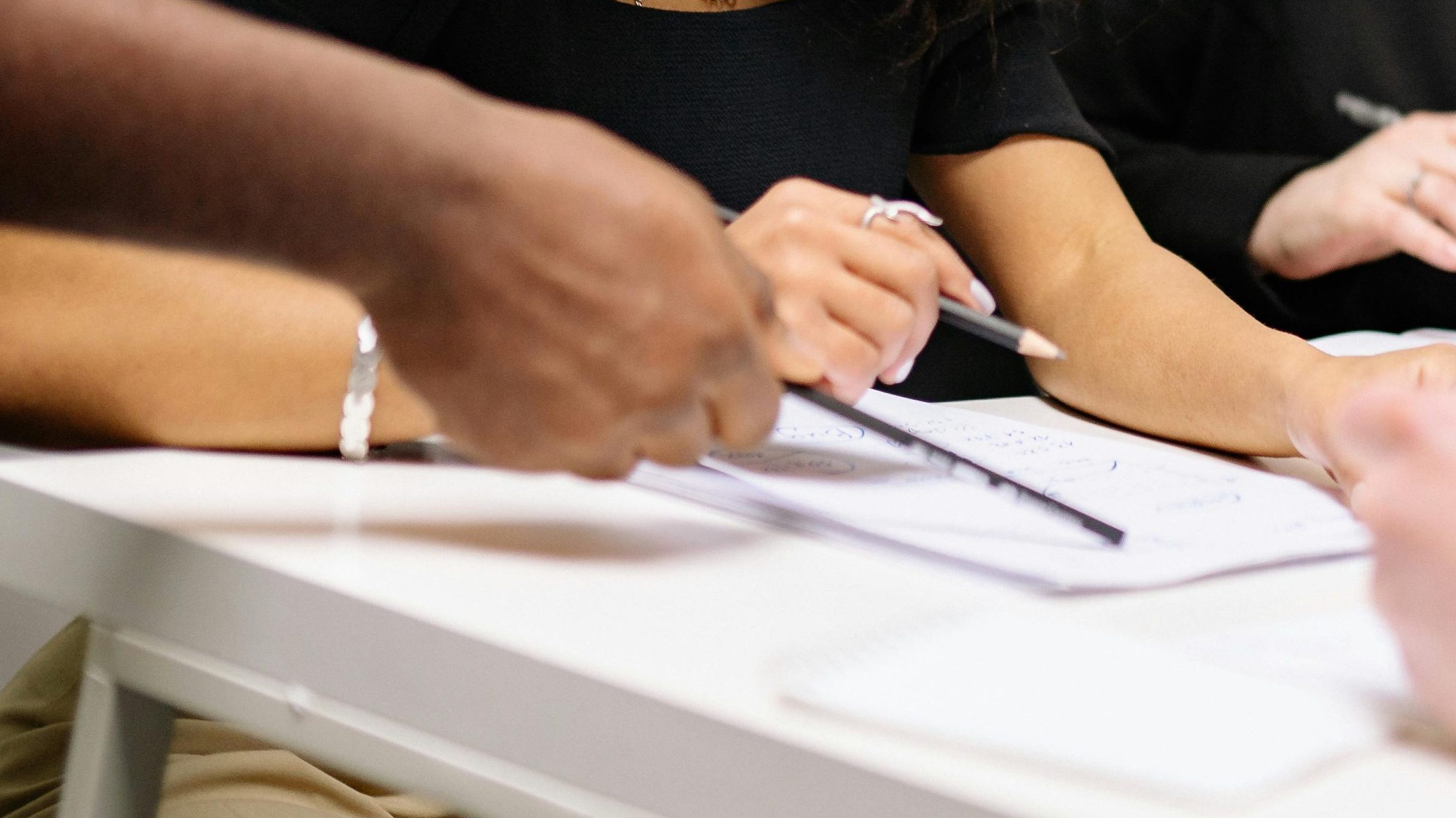 A diverse group of professionals working together in a contemporary office setting, fostering teamwork and creativity.